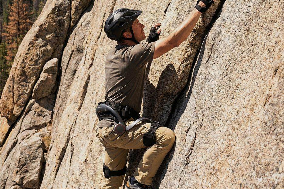 Climber wearing an AI exoskeleton on a rock face