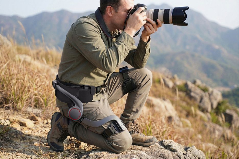 Photographer in the mountains wearing an AI exoskeleton